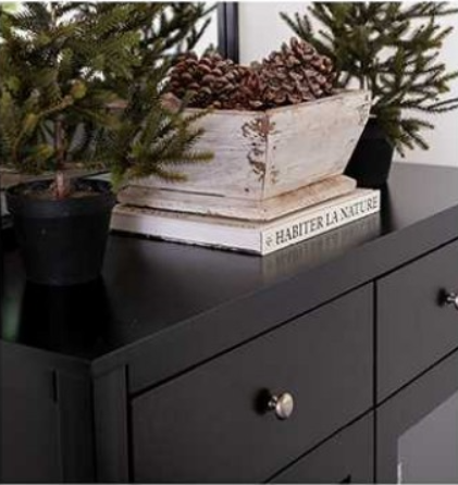 Dining room with dark table, chairs, chandelier, fireplace, and two side cabinets.