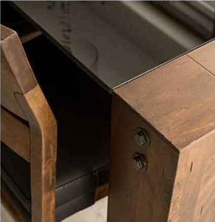 Wooden dining table with eight chairs, black cushions, in front of a window.