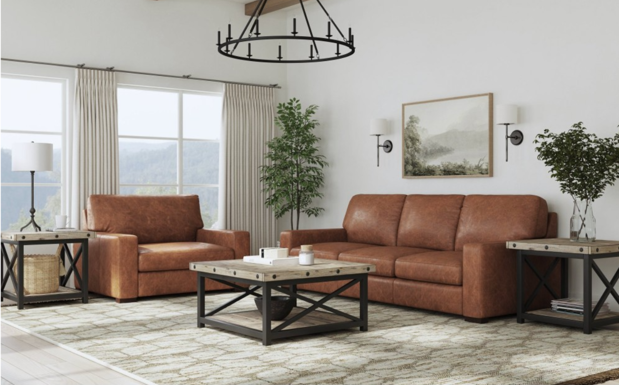 Brown leather sectional sofa in a rustic living room with a coffee table and rug.