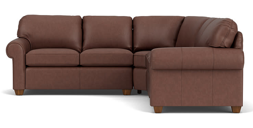 Cream-colored three-cushion sofa with rolled arms, wooden feet.