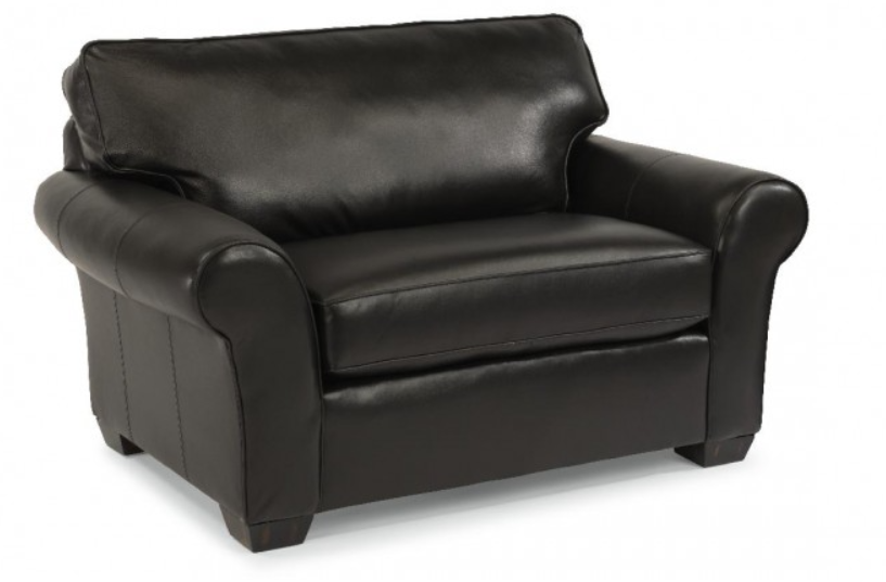 Yellow upholstered armchair with a patterned pillow.