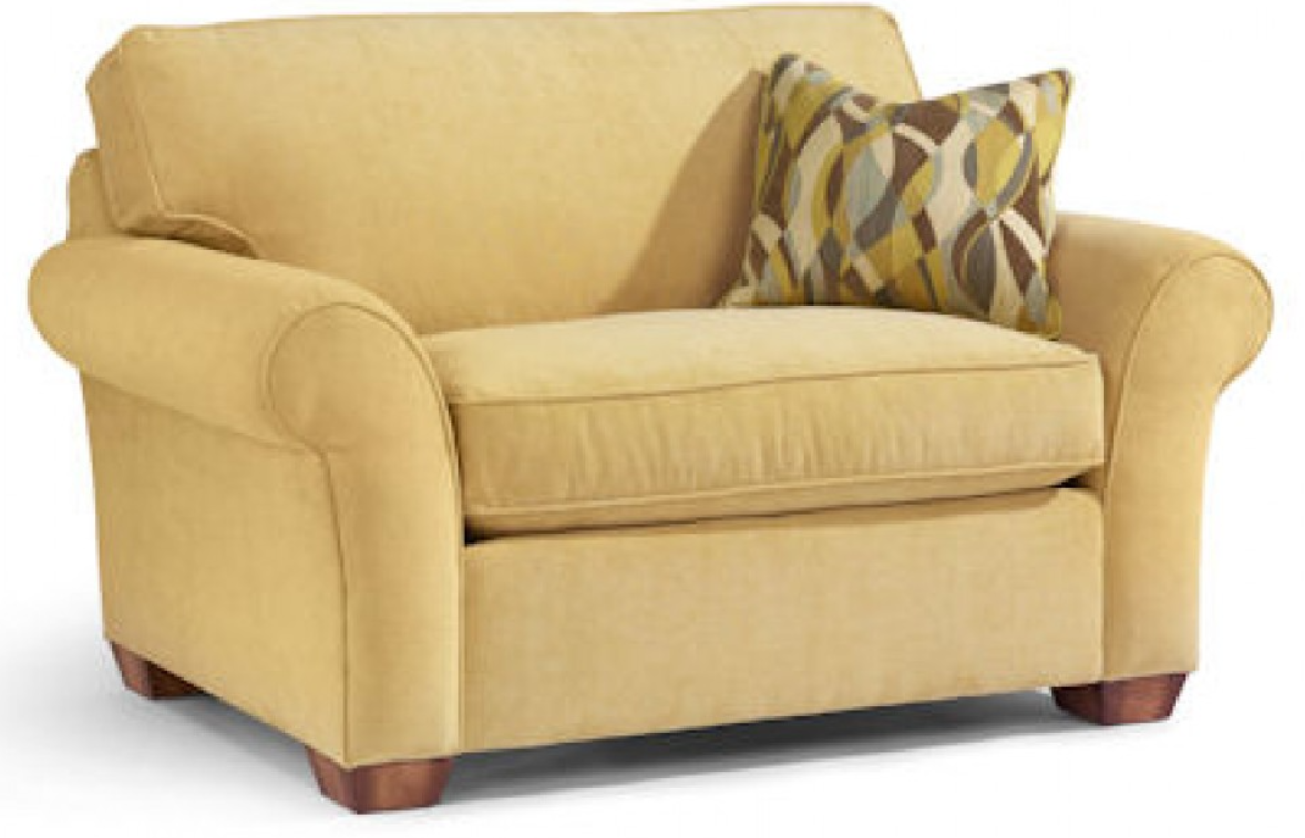 Yellow upholstered armchair with a patterned pillow.