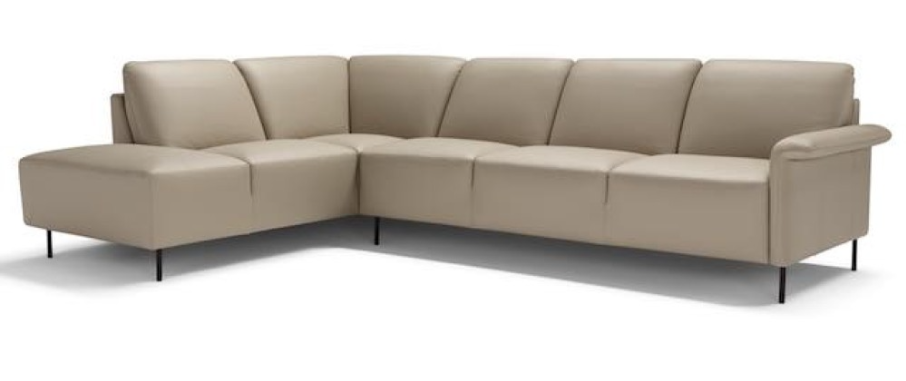 Beige leather sectional sofa with black legs.