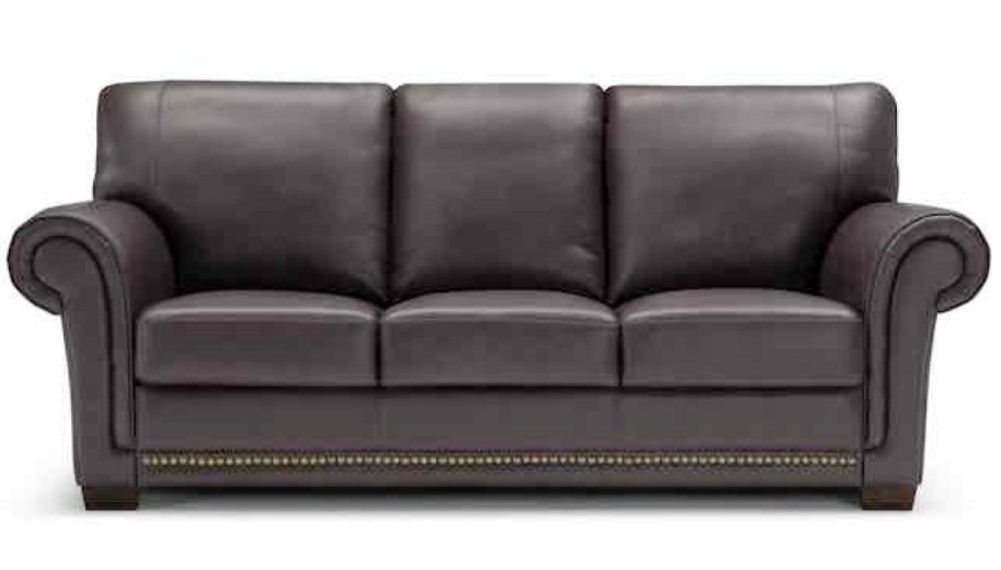 Dark brown leather sofa with three cushions, rolled arms, and nailhead trim.