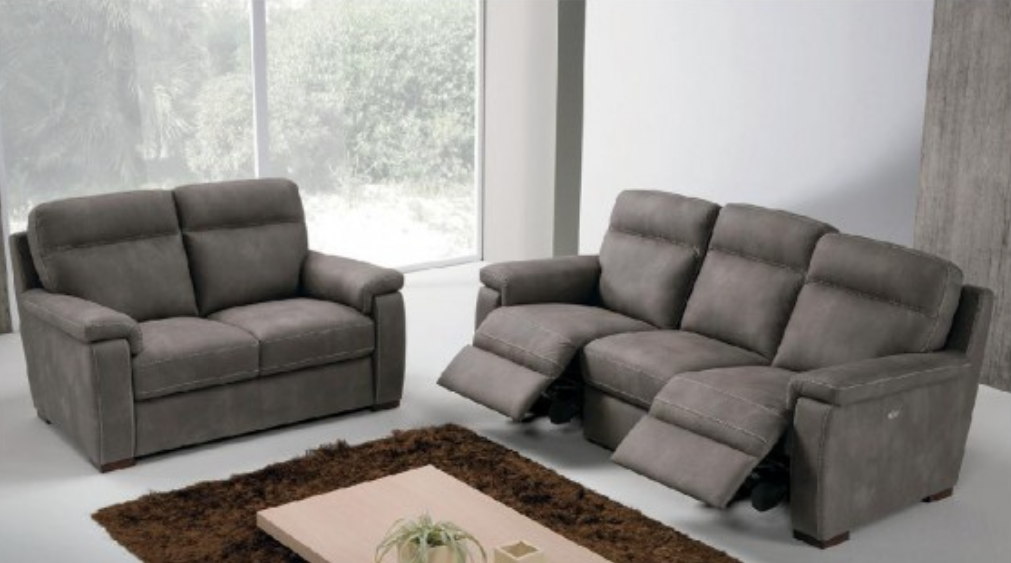 White, curved leather sofa with four reclining seats.