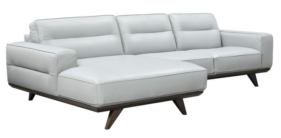 Light gray upholstered armchair with wood base.