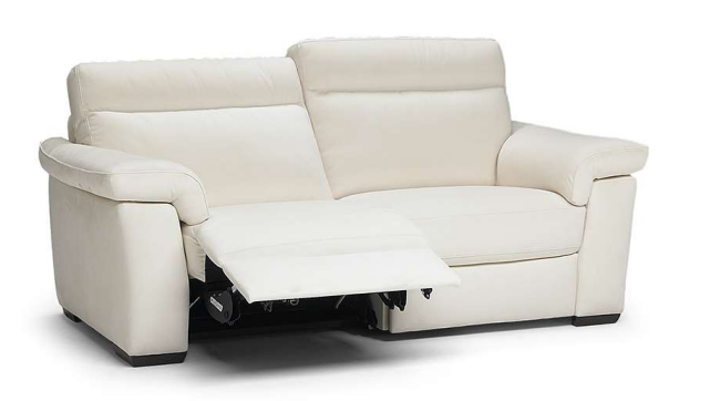 White leather sectional sofa with reclined footrest and curved ottoman.