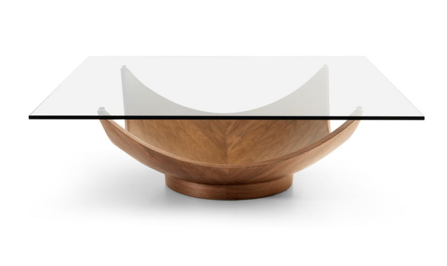 Square glass-top coffee table with a light-brown wooden, petal-like base.