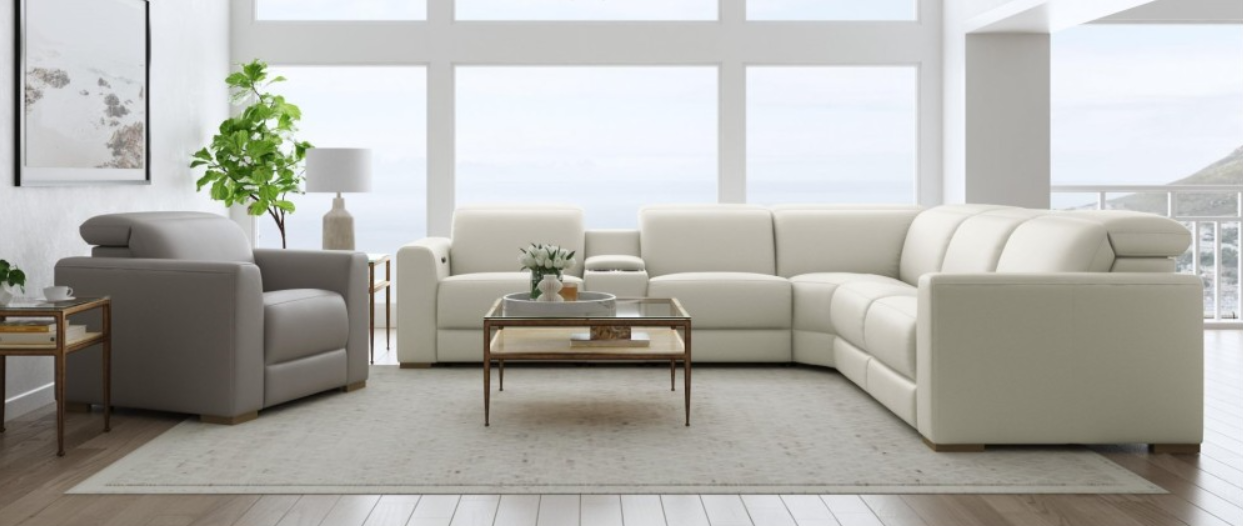 Beige leather sectional sofa with a built-in cup holder, set against a white background.