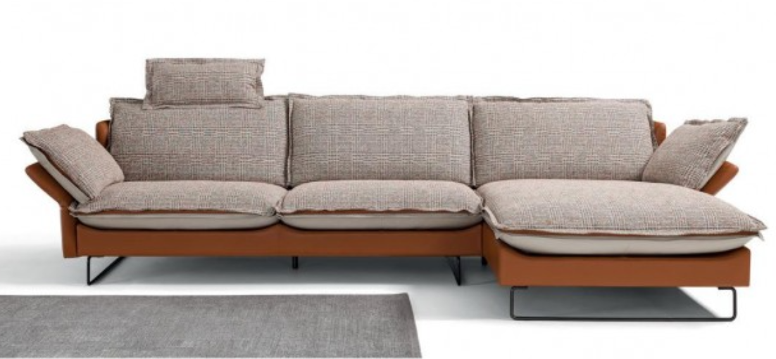 Brown and beige sectional sofa with cushions and chaise lounge.