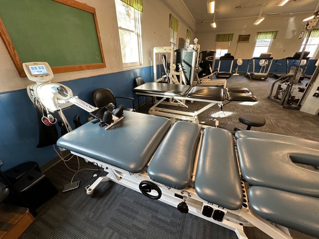 Physiotherapy equipment in a treatment room. Tables, machines, and medical devices.