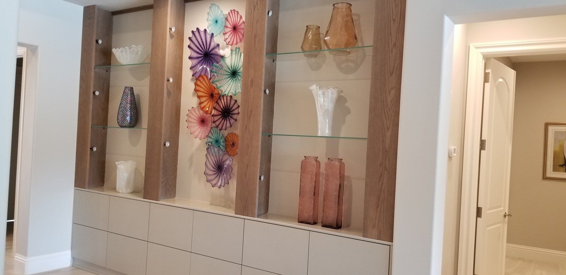 Custom art wall cabinetry by Unique WoodWorx
