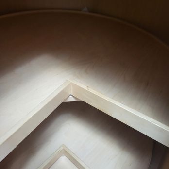 A close up of a wooden frame on a table.