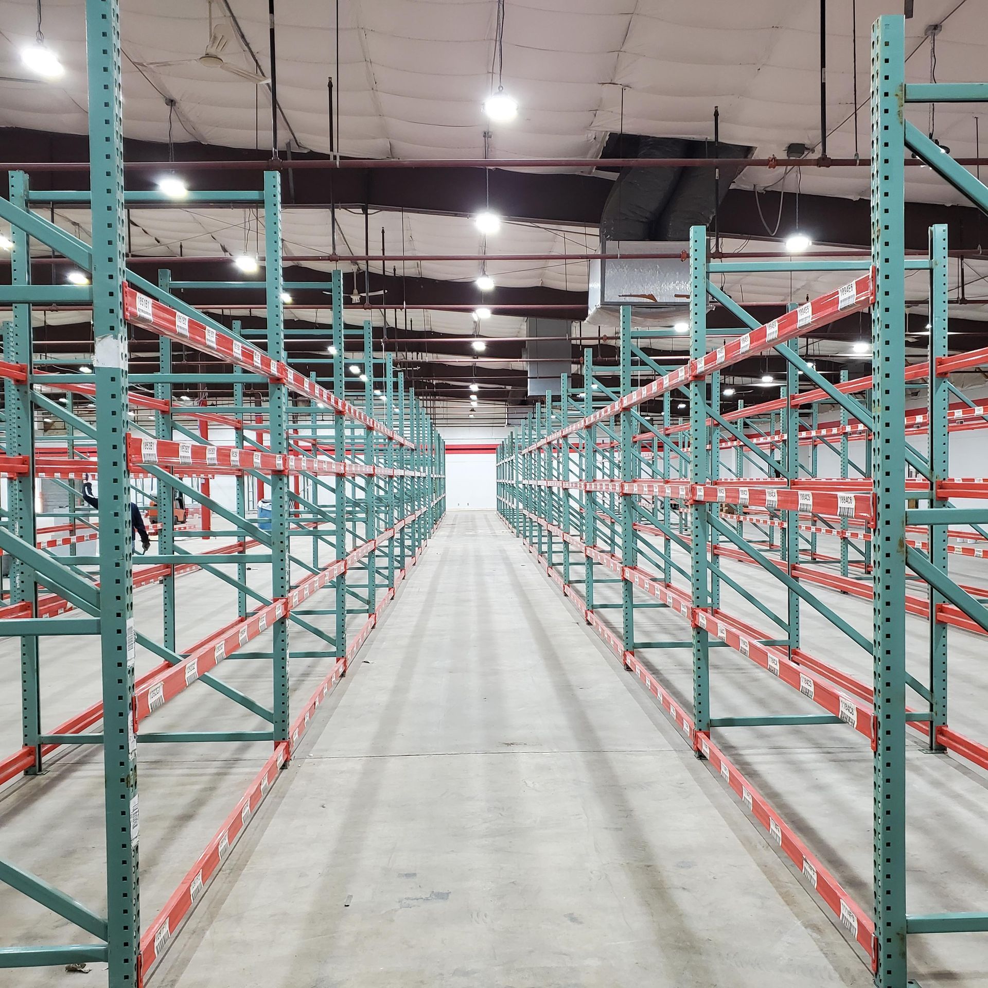 An empty warehouse with lots of shelves and racks