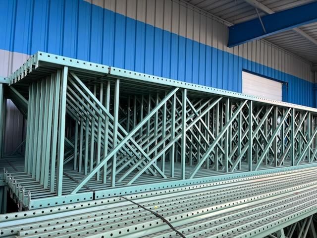 A warehouse with a lot of metal structures stacked on top of each other.