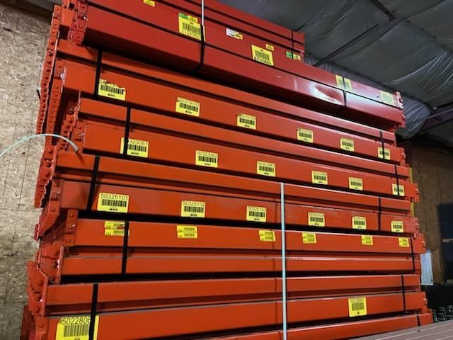 A stack of orange pallets in a warehouse