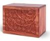 A wooden box with a carved design on it is on a white background.