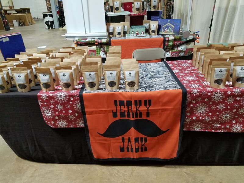 A table with a sign that says jerky jack on it