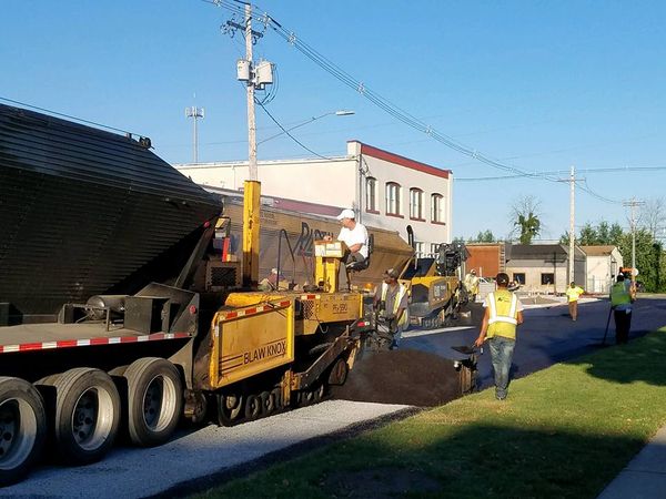 Workers paving road - Dorr, MI - Black Gold Transport, Inc.