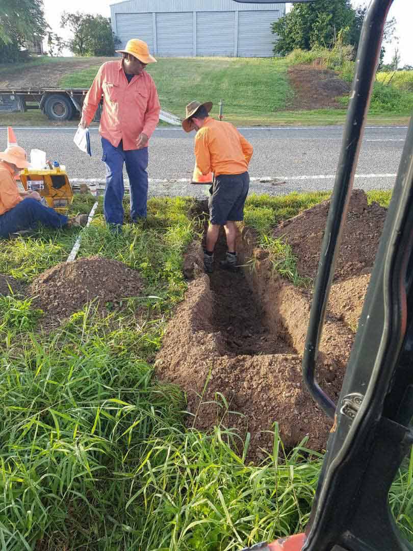 Workers Digging Hole In Soil — Drainage in Townsville QLD