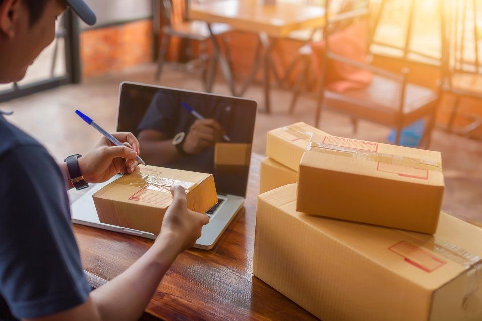 man holding a pen and a package