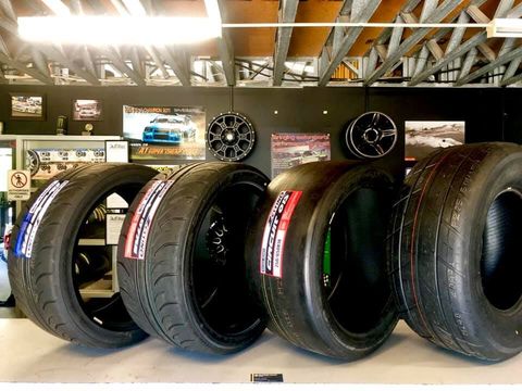 new & used tyres lined up inside tyre shop