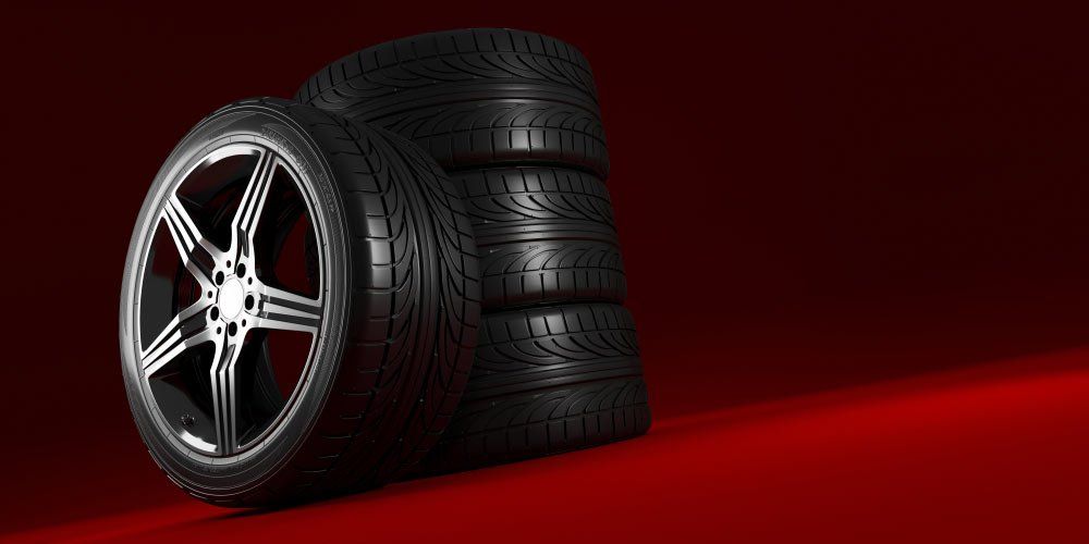 Car Wheels Set On Red Background — A1 Supercheap Tyres in Molendinar, QLD