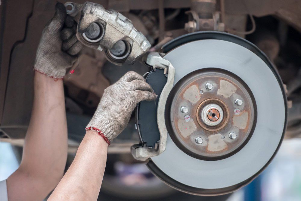 Mechanic Repairing Car Brake Pads — A1 Supercheap Tyres in Molendinar, QLD