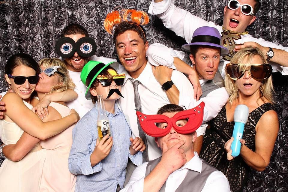 friends enjoying at a cloee photo booth in Manor