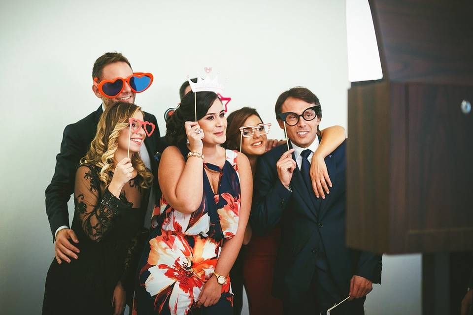 friends and the celebrant of a quinceanera enjoying and posing at a photo booth rental in Atlanta