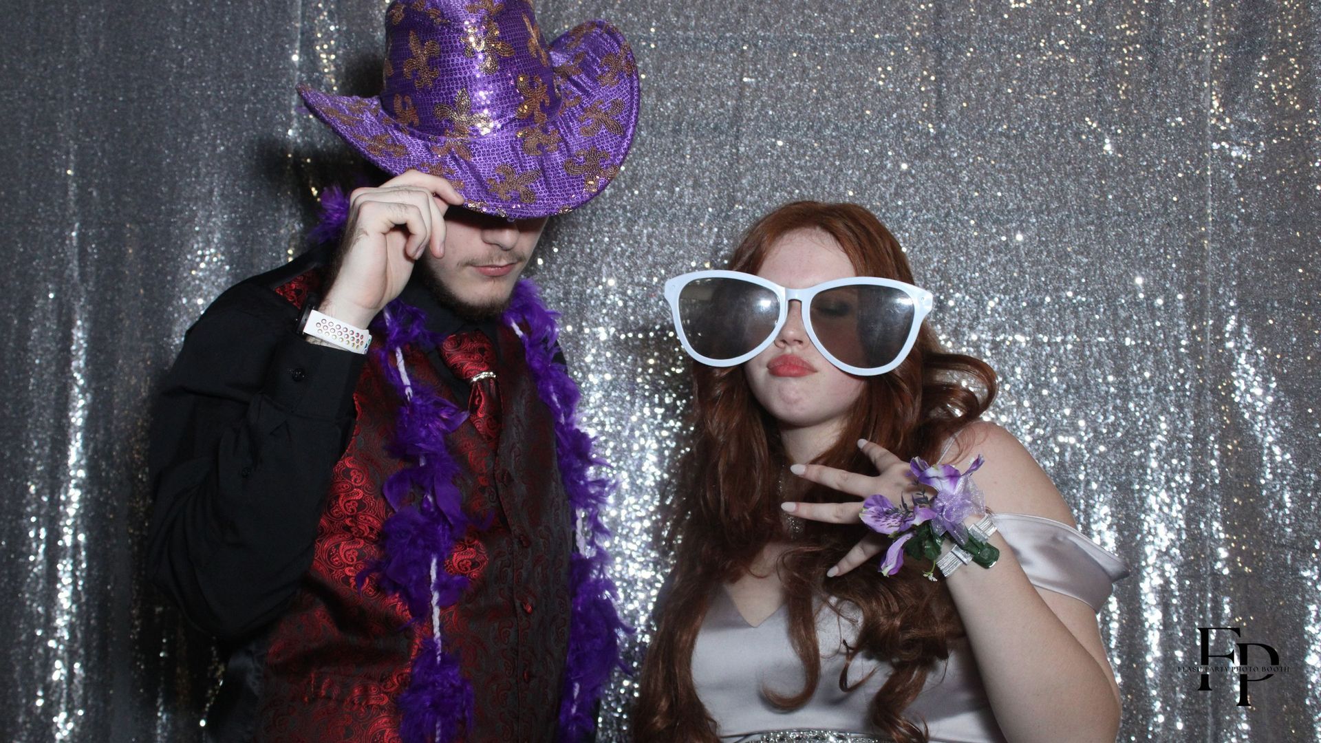 A couple wearing sunglasses poses in a 360 Photo Booth, capturing a fun and stylish moment together.