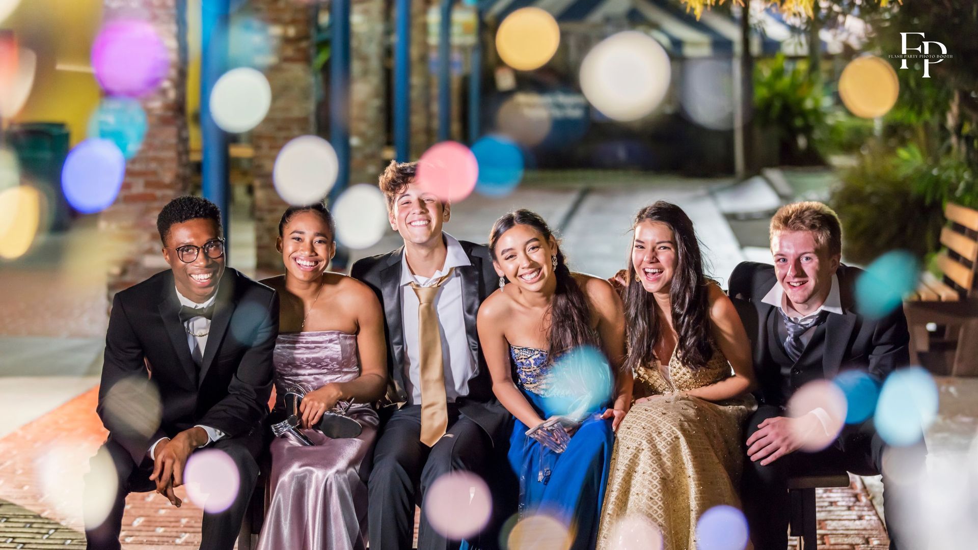A group of prom attendees all dressed up striking a pose in North Austin