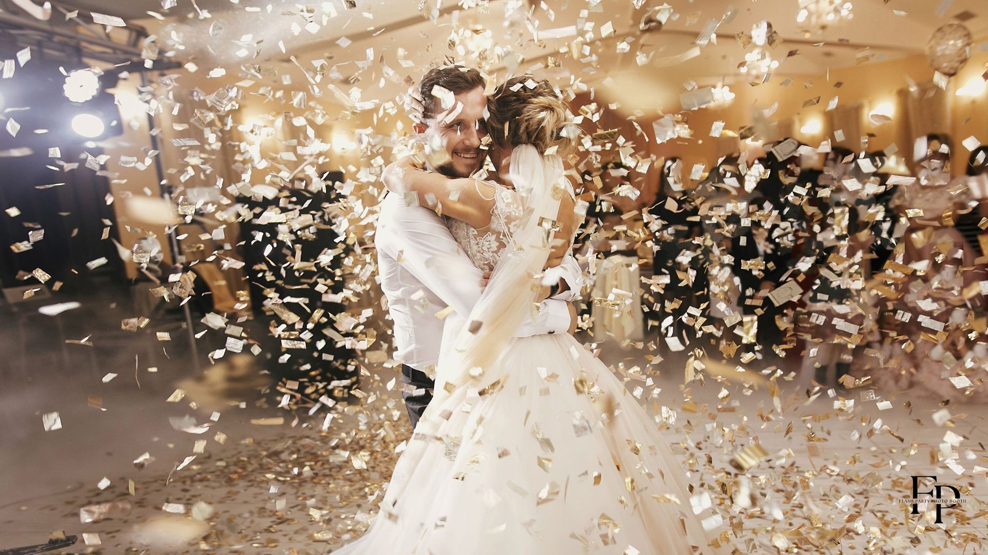 The bride and groom showered in confetti while embracing each other after the wedding celebration