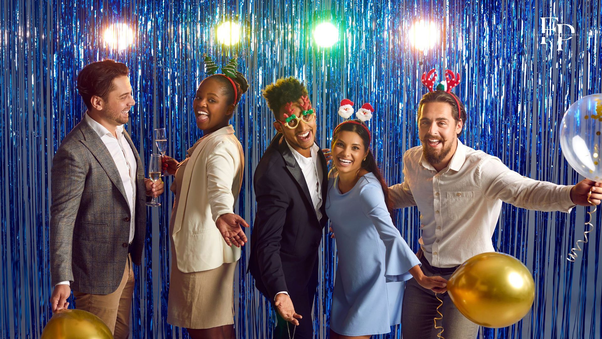 A group of friends enjoy the interactive experience of the flash party photo booth, complete with an assortment of props, in Waco.
