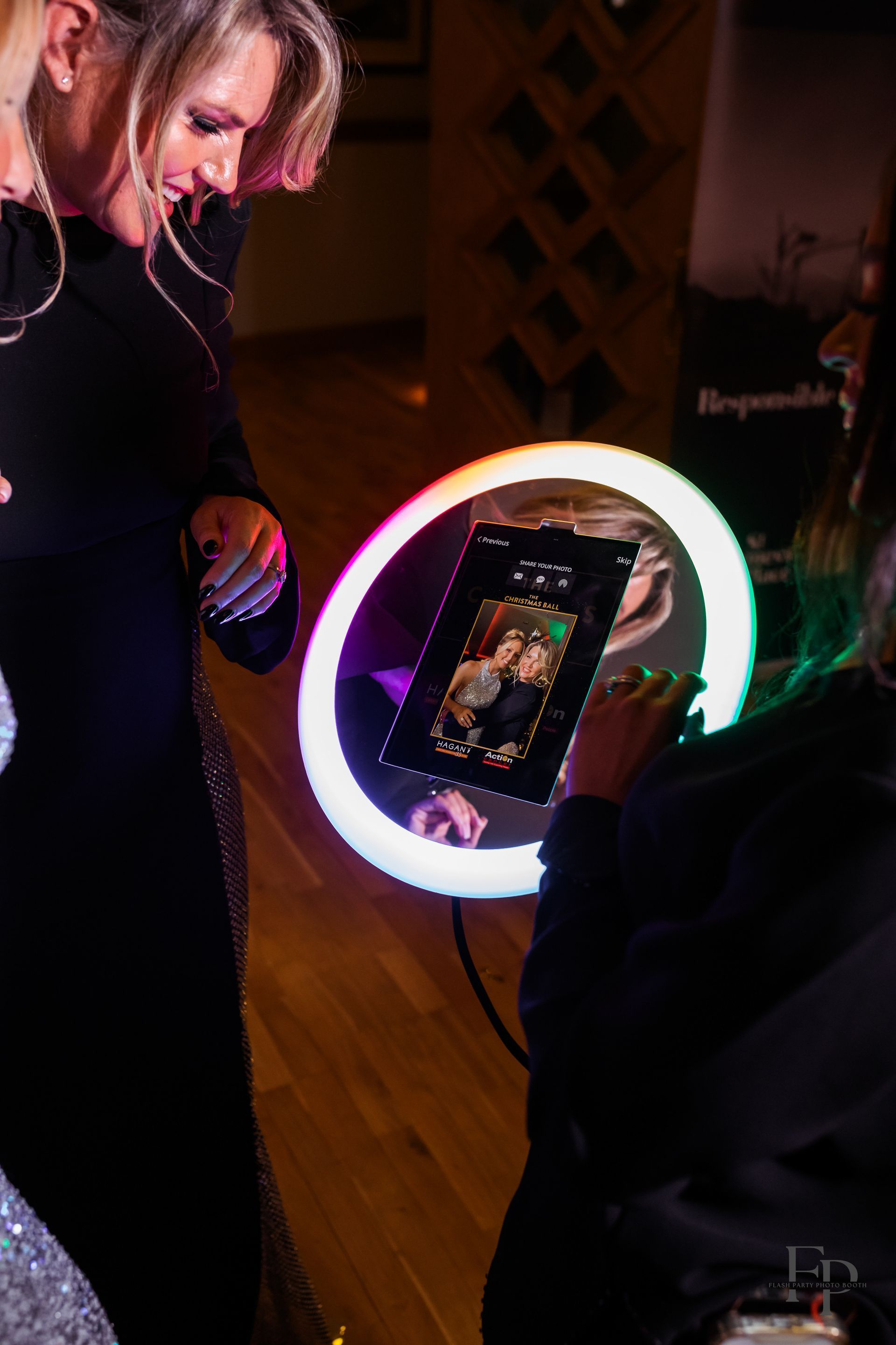 A woman taking a selfie with a Roamer Photo Booth.