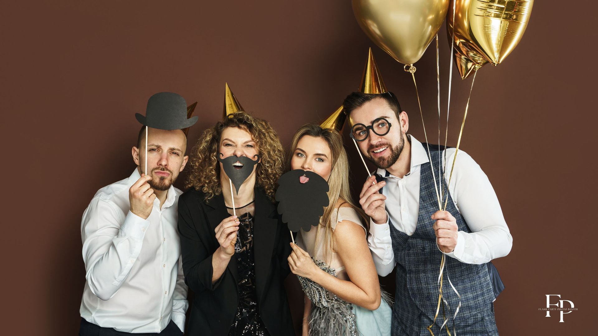 A group of friends posing at a photo booth rental for a corporate event in Manor, holding up silly props and making funny poses