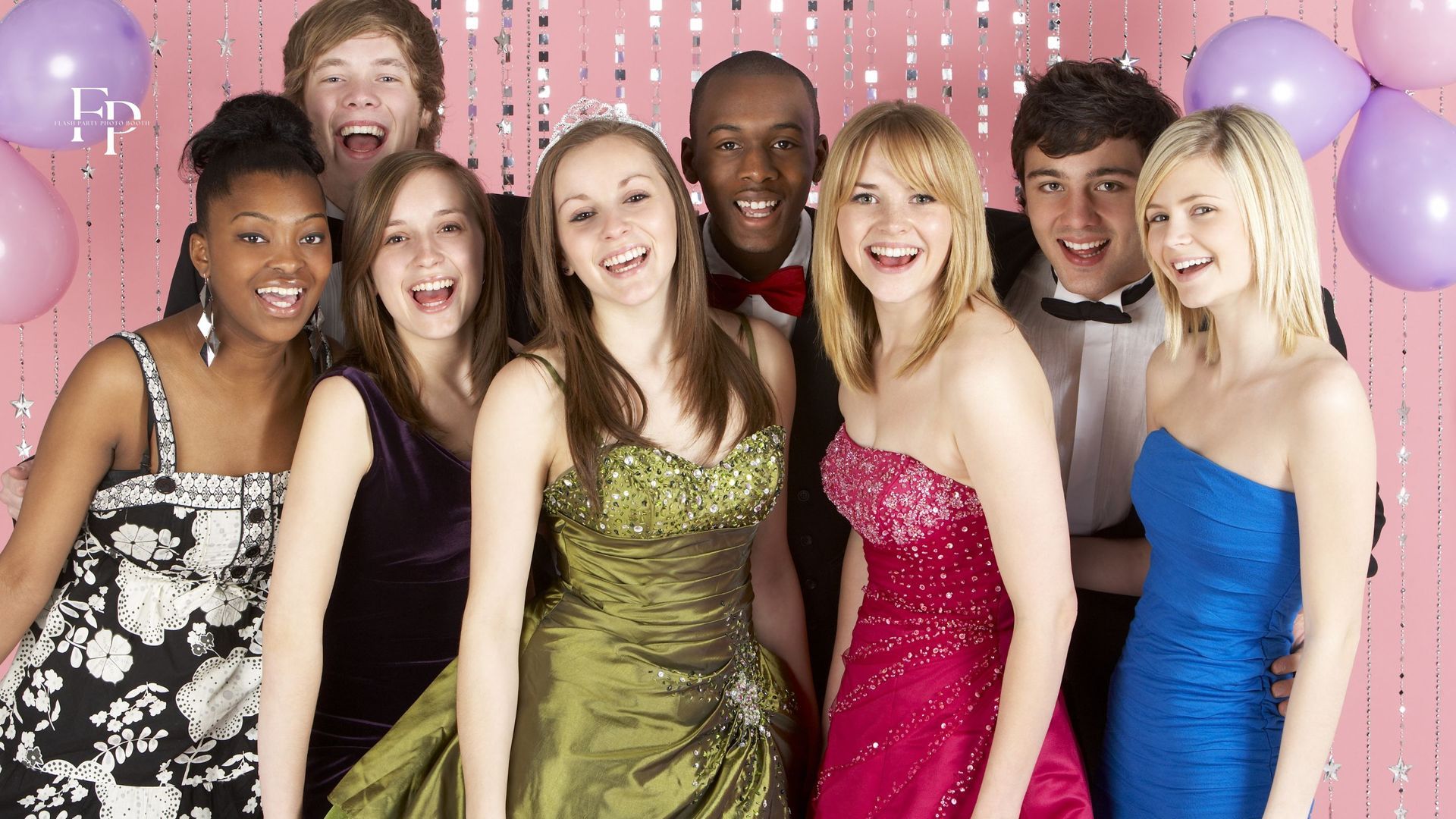 Friends creating lasting memories and sharing laughs in the DFW prom party's photo booth rental.