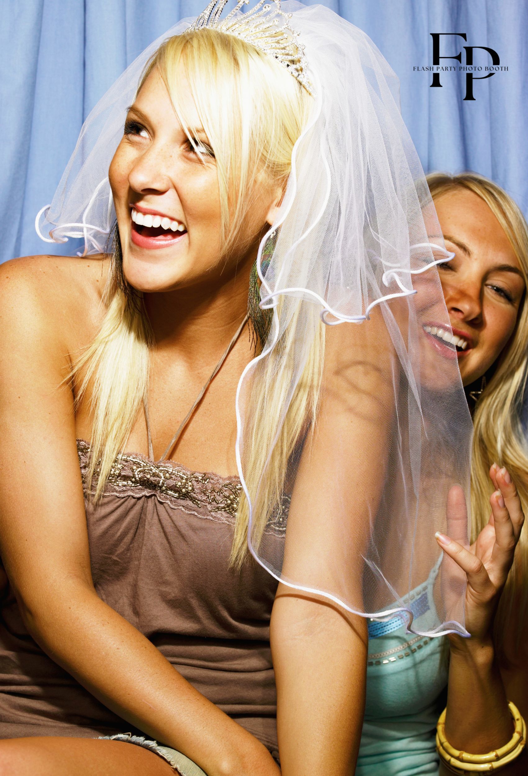 two friends posing before a San Jose astro booth during a bridal shower 