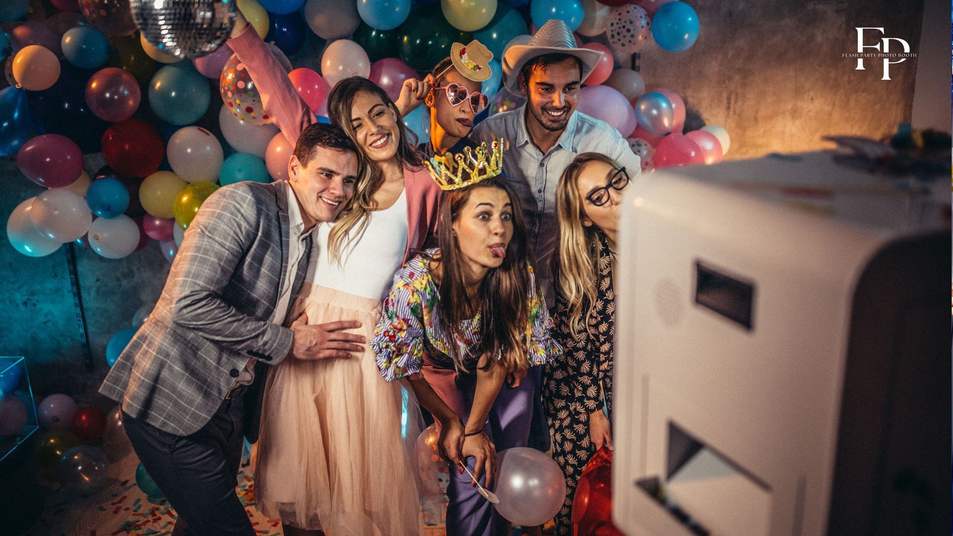 Graduates in San Antonio and friends make memories in a flash party photo booth.