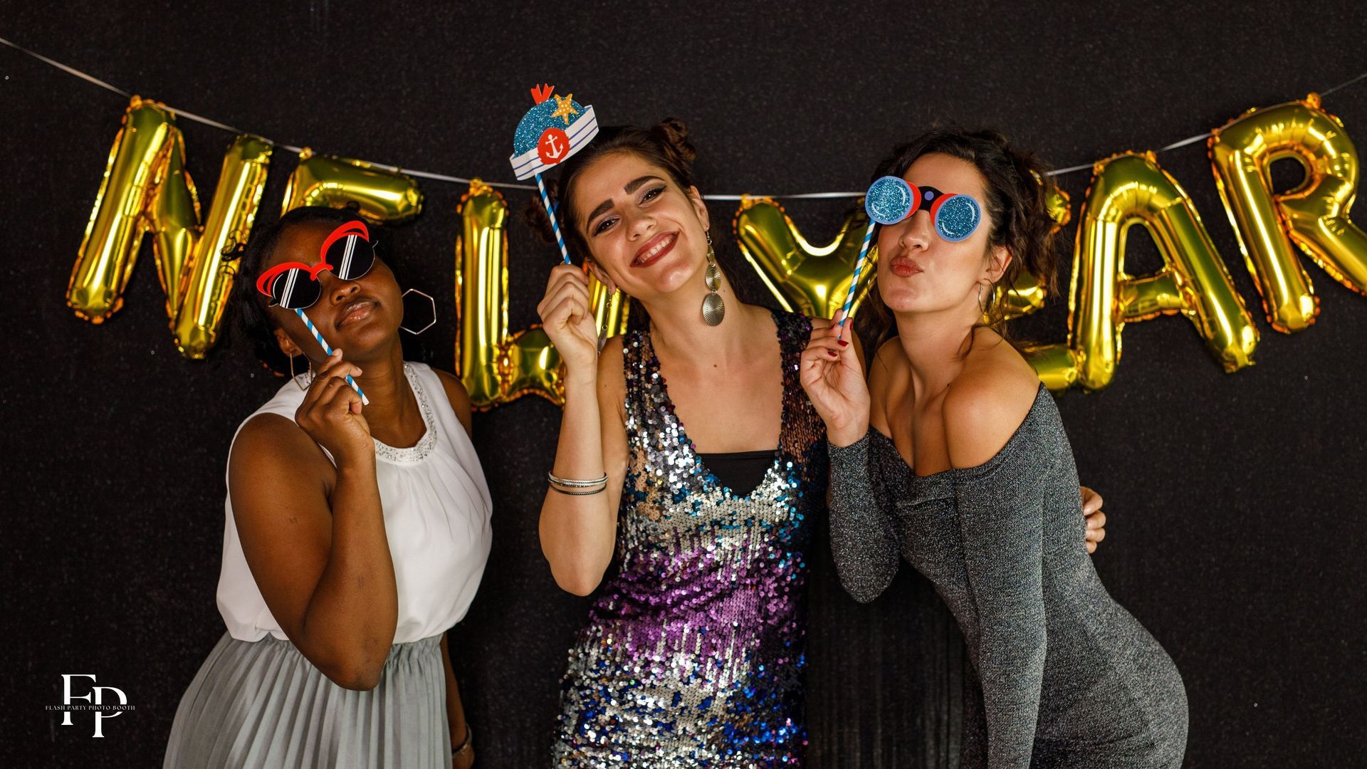 Friends pose with their props at a new year's eve party in Waco.