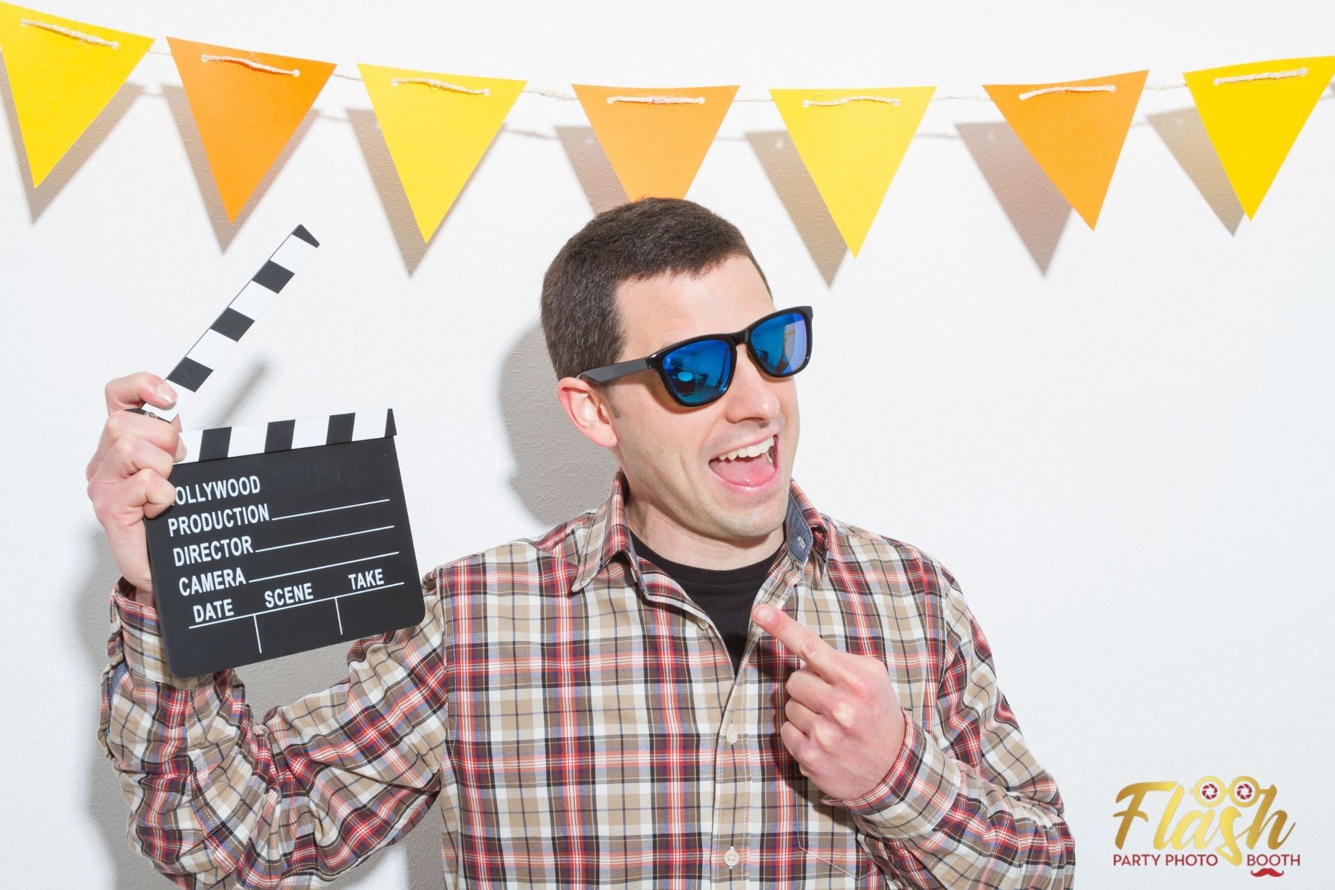 a man posing and trying out the new features of a photo booth rental at an event