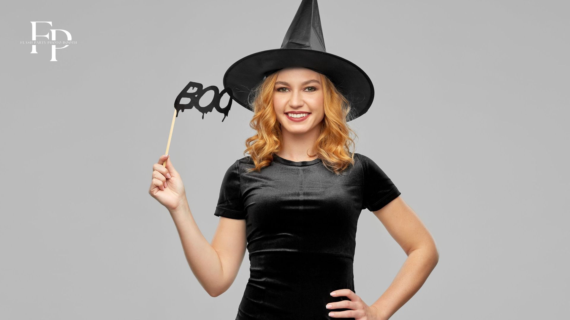 A woman striking her best Halloween pose at a photo booth rental
