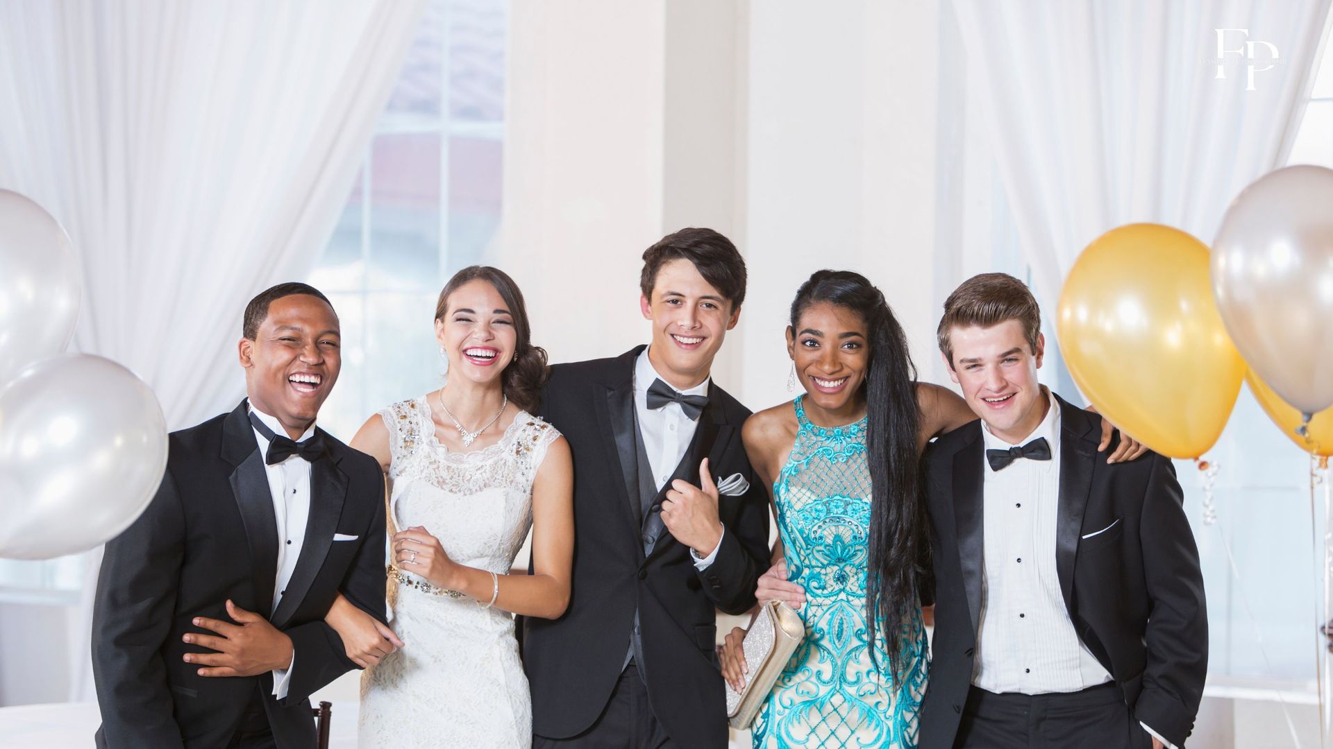 A group of friends having a laught and posing at a beautifully set up prom venue in Midland