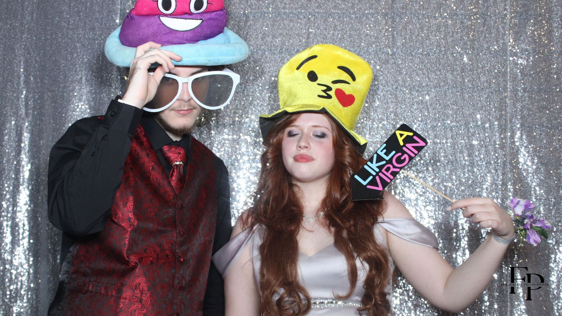 Prom attendees wearing comical hats posing for a photo in the Overhead 360 Photo Booth.