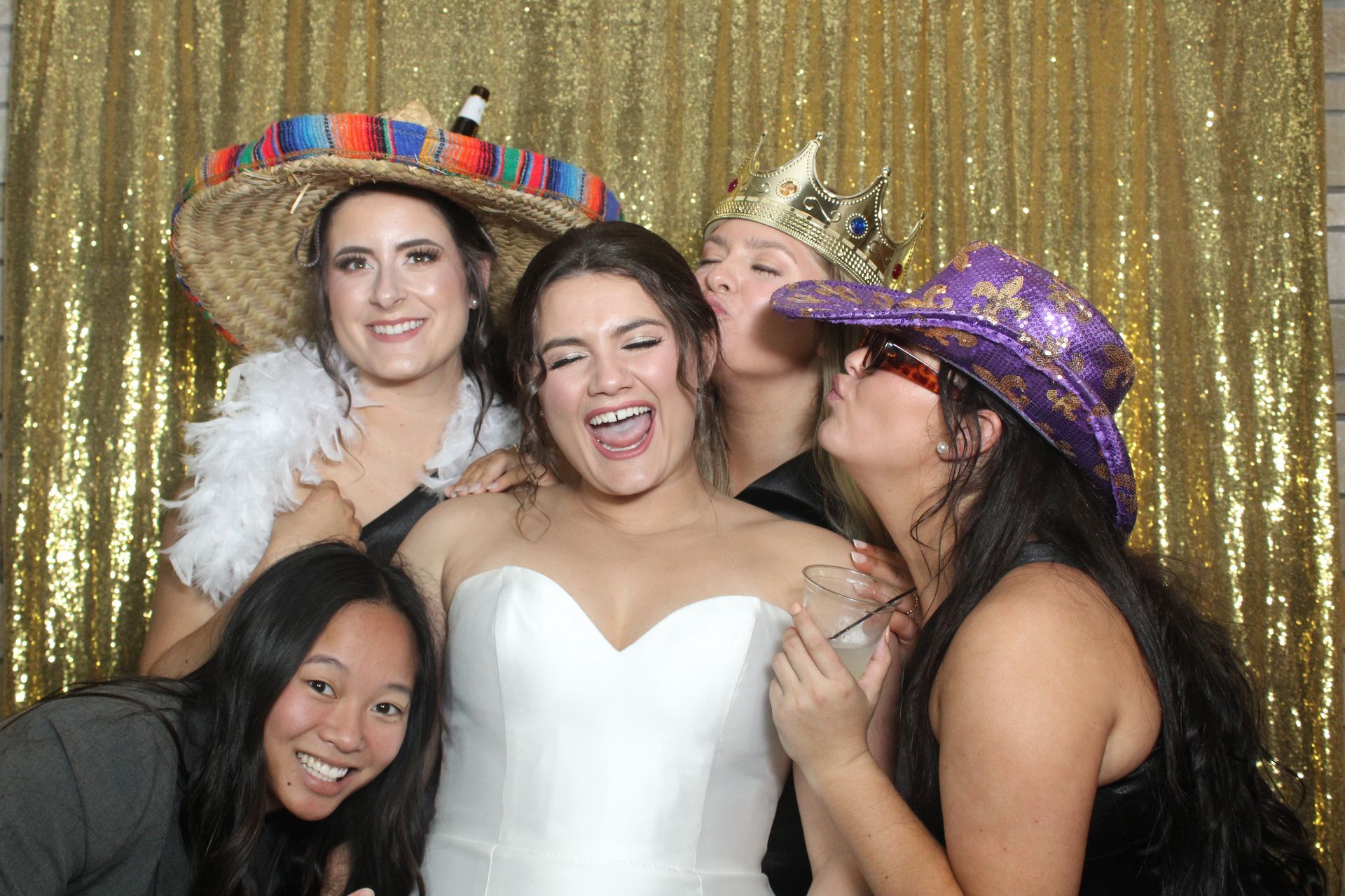A happy group of women posing with the lovely bride in a Mirror Photo Booth