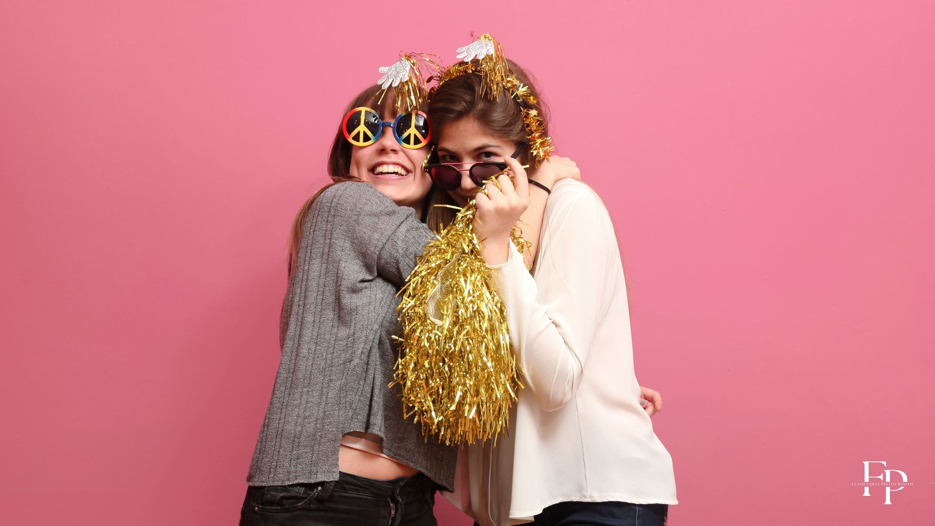 With all the excitement of a birthday party in full swing, two friends share a lighthearted moment at the photo booth rental in DFW, their smiles infectious and their spirits high.
