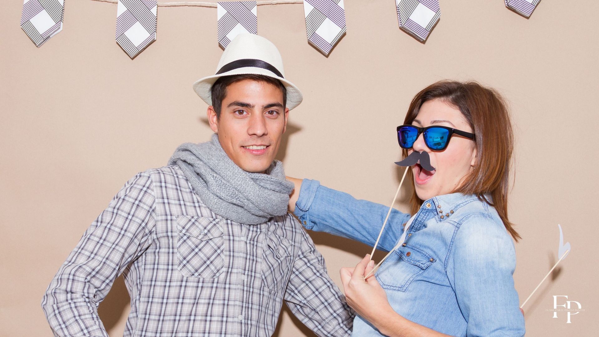 A couple posing at a photo booth rental at birthday party set up in Mansfield