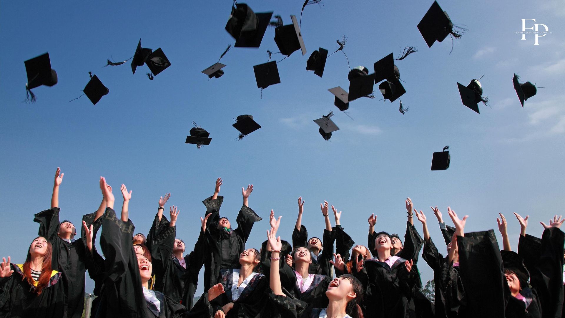 San Jose graduates toss their hats in celebration of their achievements.