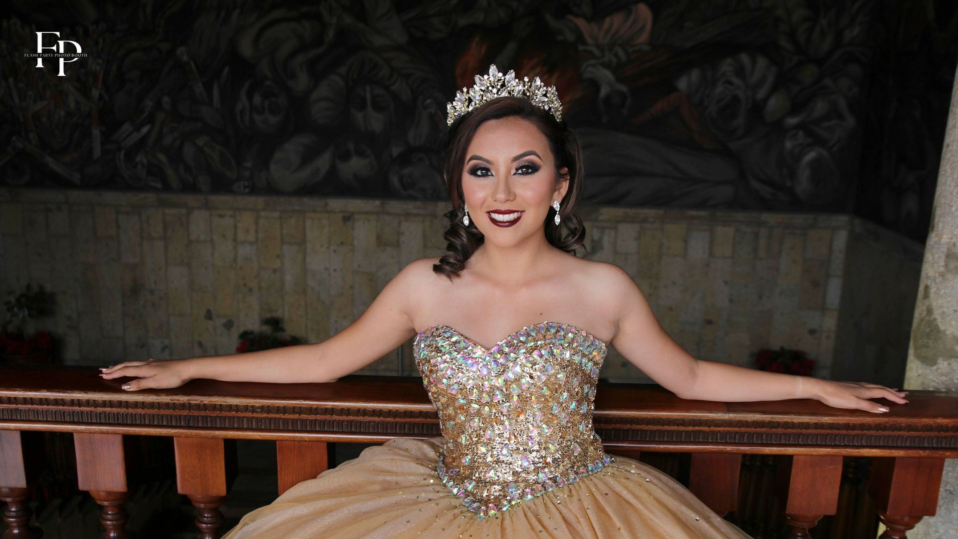 The celebrant in a beautiful golden  gown, posing at her quinceanera venue in Midland