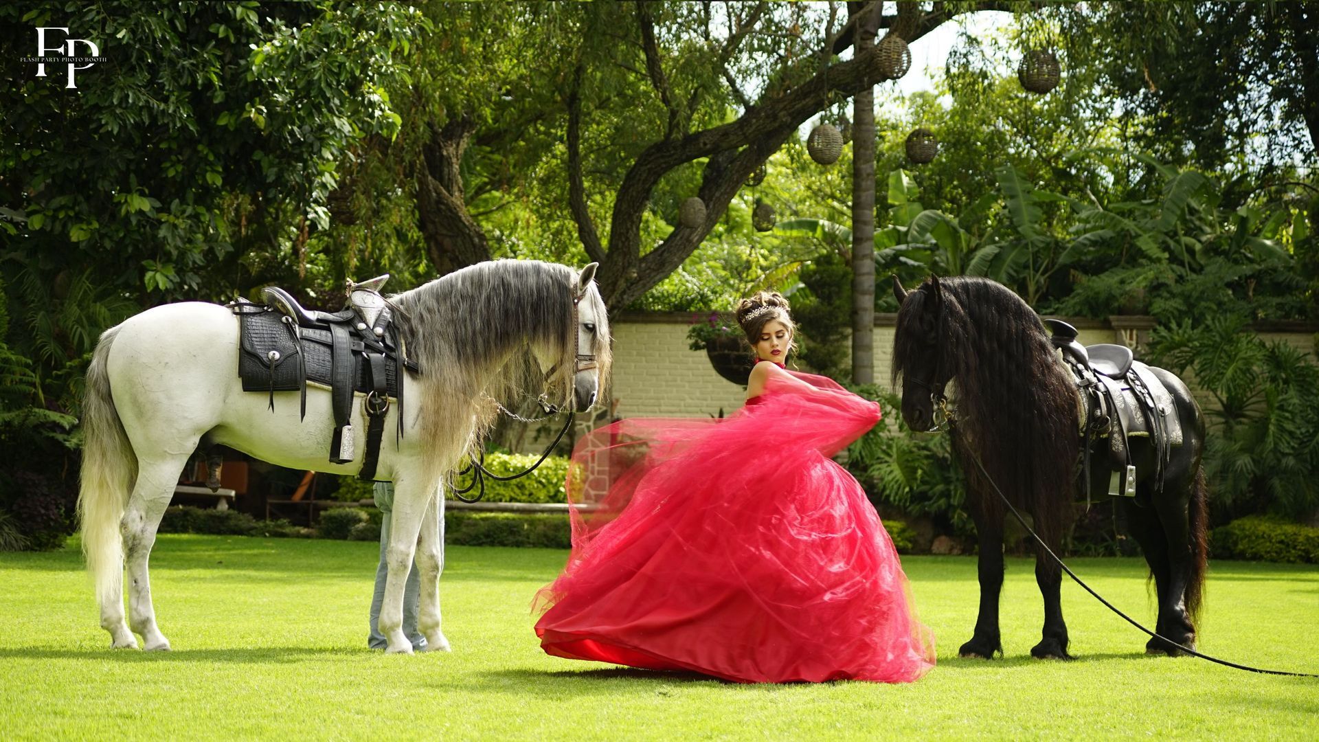 A celebrant in a red gown beside a white horse striking a pose for her quinceanera celebration at Manor